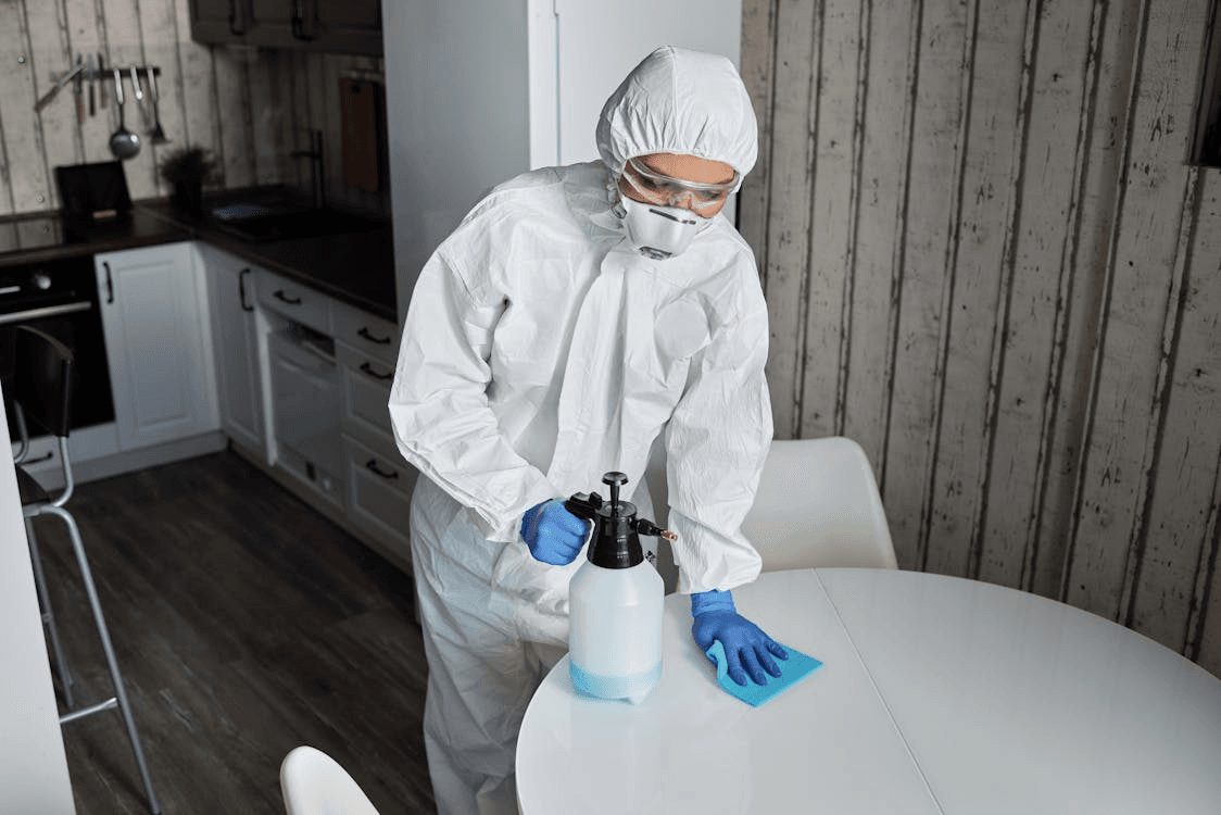 person cleaning a table